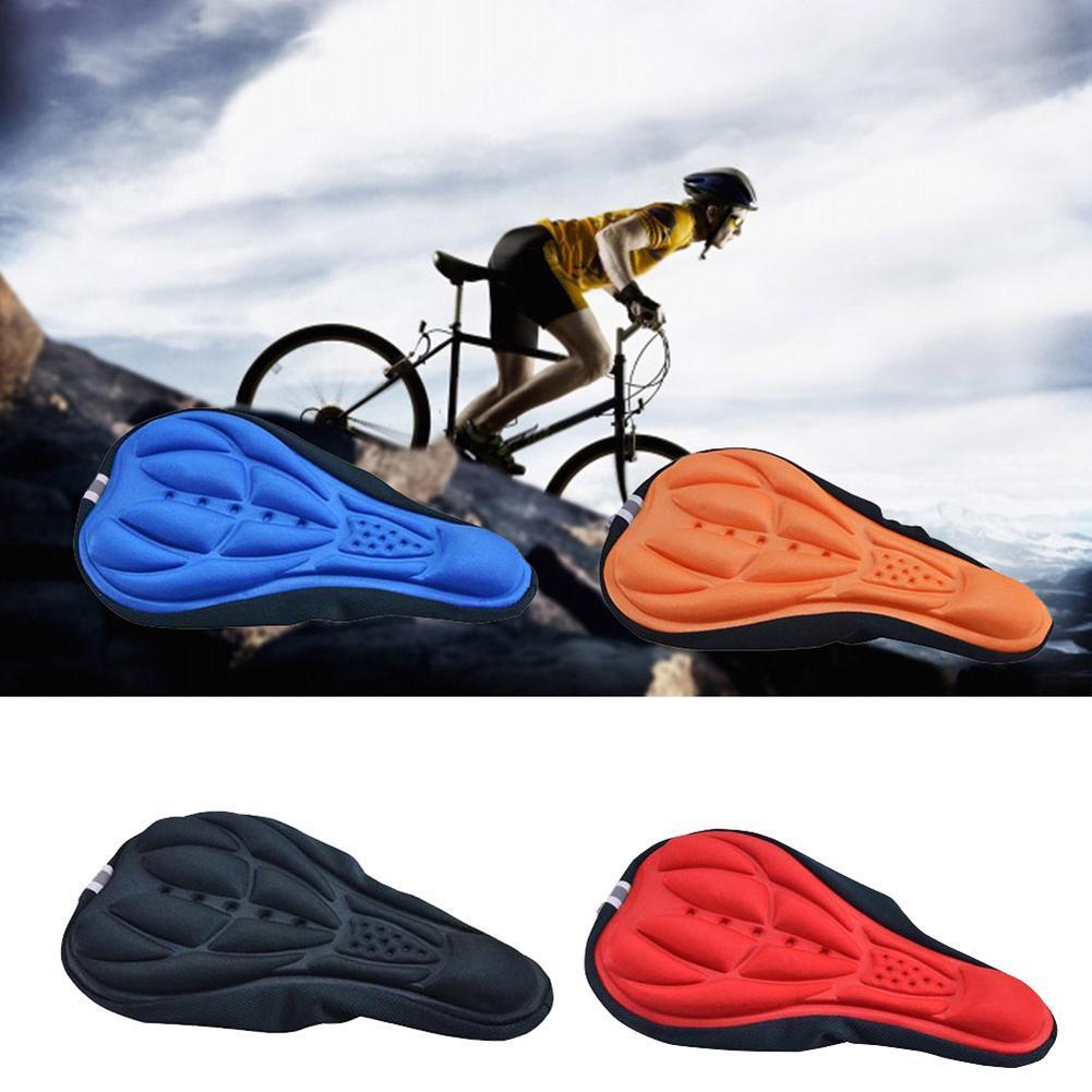 3D Gel Bike Seat Cushion Cover in blue, orange, black, and red with cyclist riding in the background on a mountain trail.