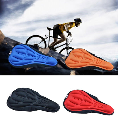 3D Gel Bike Seat Cushion Cover in blue, orange, black, and red with cyclist riding in the background on a mountain trail.