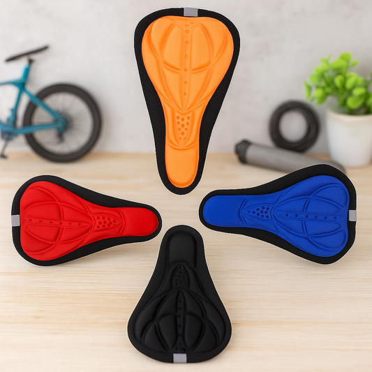 4 colorful 3D Gel Bike Seat Cushion Covers displayed on a wooden table with a bicycle in the background.