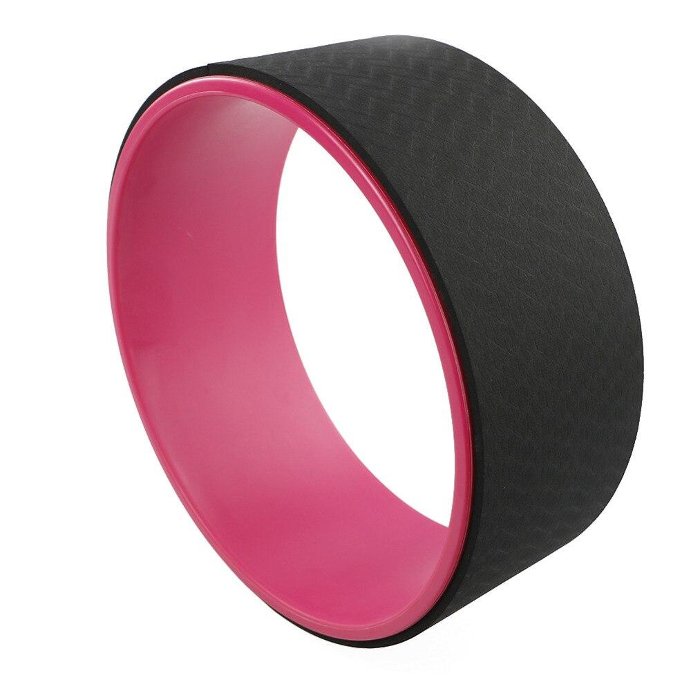 Yoga Pilates Circle Ring in black and pink for enhancing balance and flexibility during workouts.