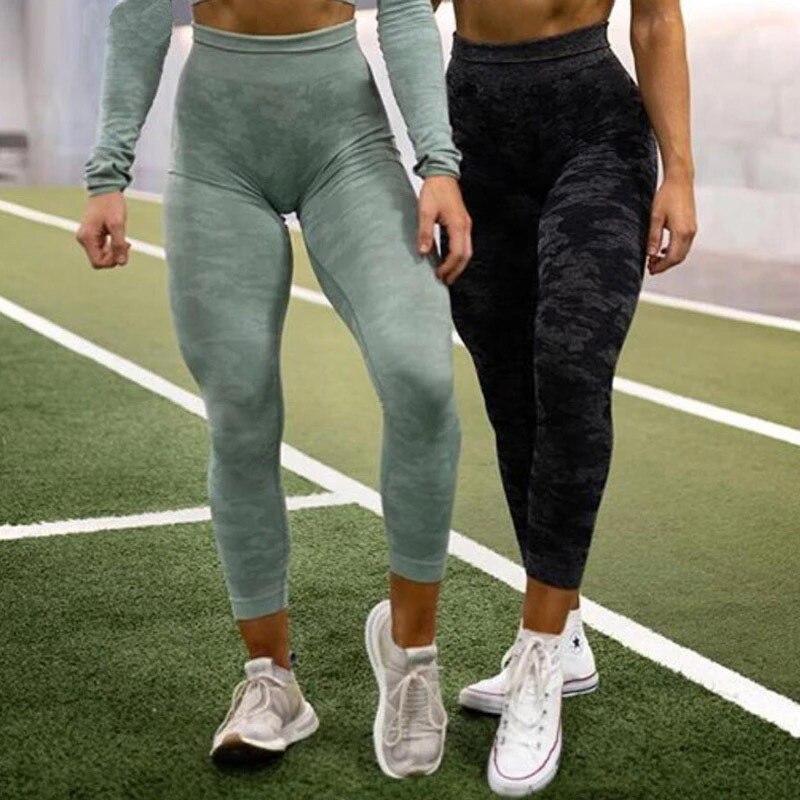 Two women wearing high waist fitness leggings in a gym setting, showcasing style and comfort.