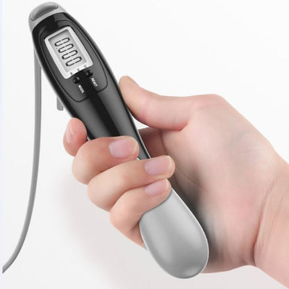 Smart cordless jump rope digital fitness tracker held in hand, showcasing its display and ergonomic design.