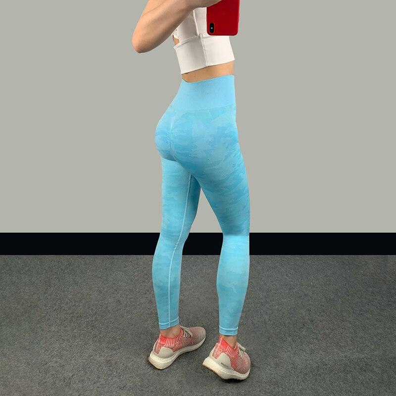 High waist fitness leggings in blue on a woman, showing a sleek design and supportive fit for optimal comfort during workouts.