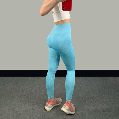 High waist fitness leggings in blue on a woman, showing a sleek design and supportive fit for optimal comfort during workouts.