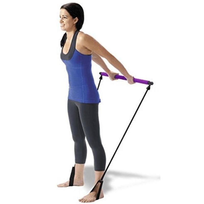 Woman using the Pilates Squat Resistance Bar with Bands for a full-body workout at home.