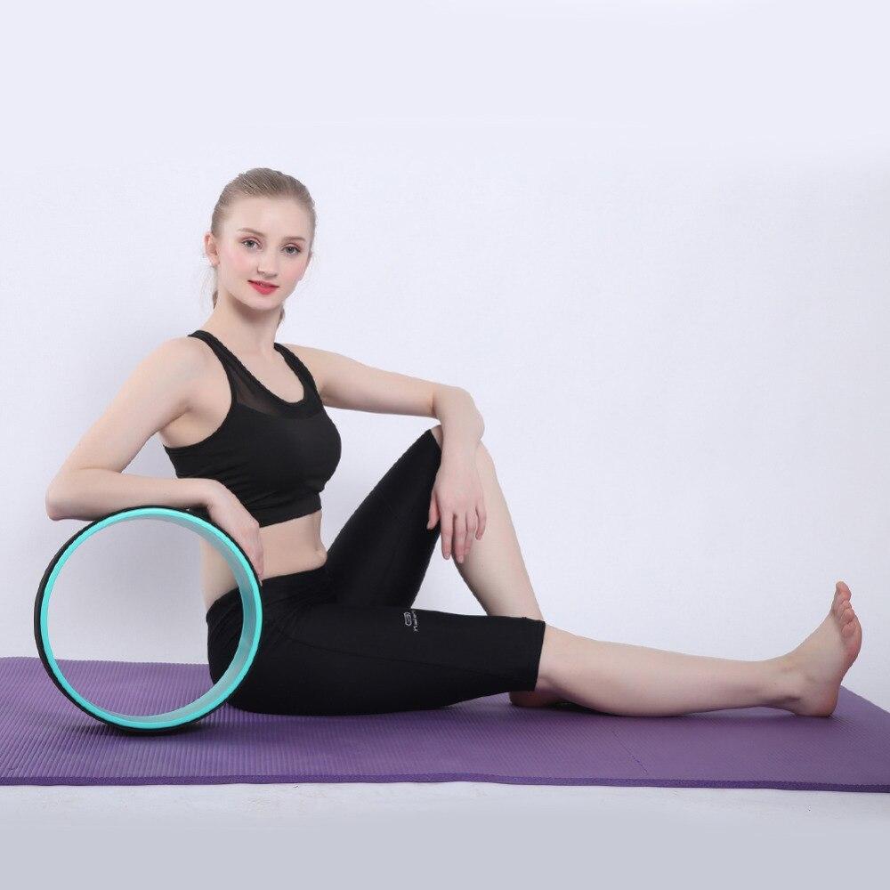 Yoga Pilates Circle Ring with a young woman performing stretches on a yoga mat, enhancing balance and flexibility.
